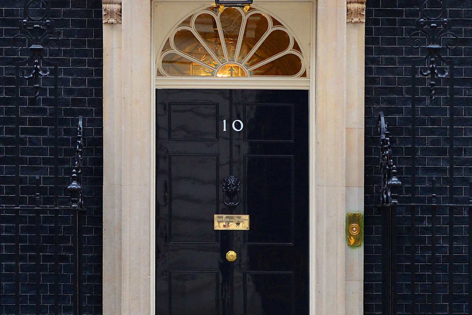 The black front door of 10 Downing Street with its lantern, fanlight and number 10